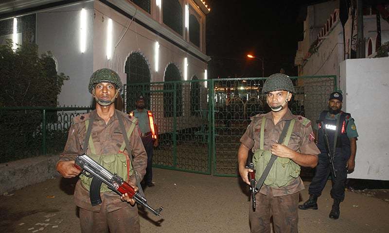 Bangladesh Border Guard members stand guard after the blasts. ─ AFP