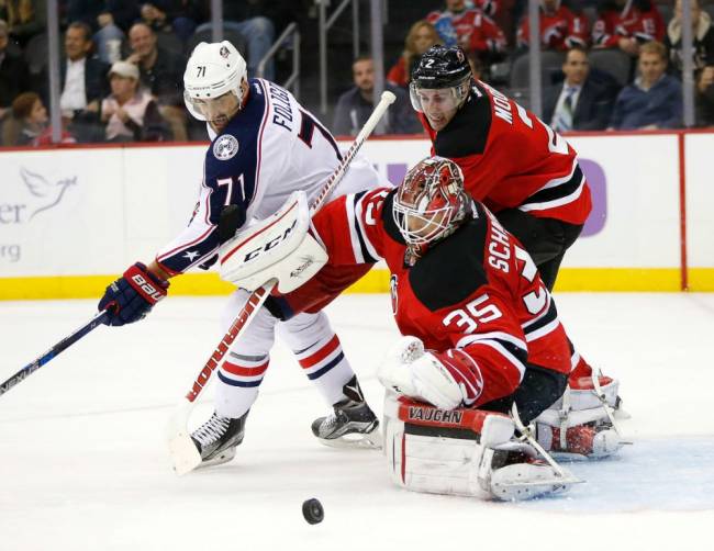 Devils goalie Cory Schneider blocks a shot as Columbus Blue Jackets left wing Nick Foligno attacks during the second period of an NHL hockey game Tuesday Oct. 27 2015 in Newark