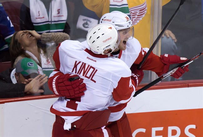 Detroit Red Wings Gustav Nyquist back of Sweden celebrates his game-winning goal against the Vancouver Canucks with teammate Jakub Kindl of the Czech Republic during the overtime period of an NHL hockey game in Vancouver B.C. on Saturday October 2