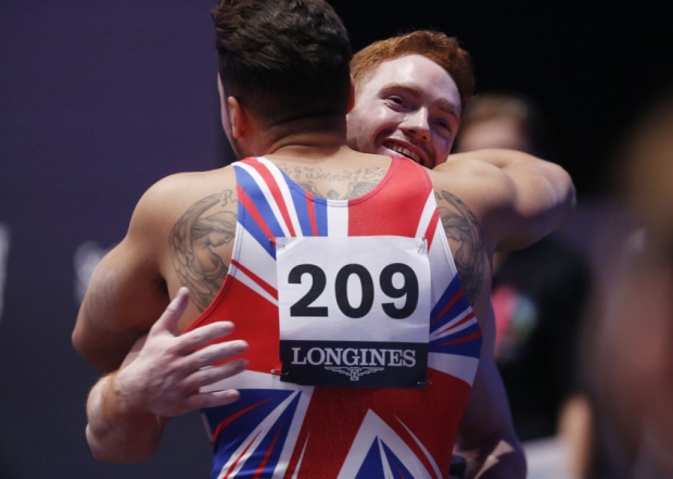 Great Britain's Daniel Purvis is congratulated by team-mate Louis Smith after competing on the parallel bars at the 2015 World Gymnastics Championships at The SSE Hydro Glasgow