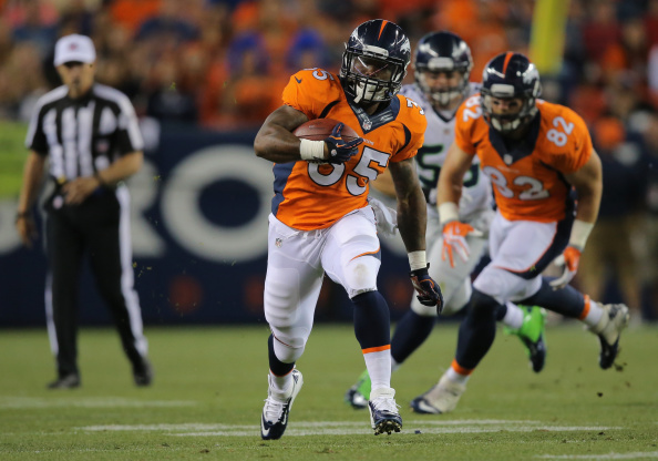 Running back Kapri Bibbs #35 of the Denver Broncos runs with the ball against the Seattle Seahawks during preseason action at Sports Authority Field at Mile High on Aug. 7 2014