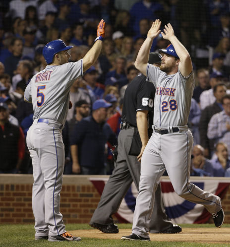 New York Mets David Wright and Daniel Murphy celebrate after scoring on a double by Lucas Duda during the second inning of Game 4 of the National League baseball championship series against the Chicago Cubs Wednesday Oct. 21 2015 in Chicago