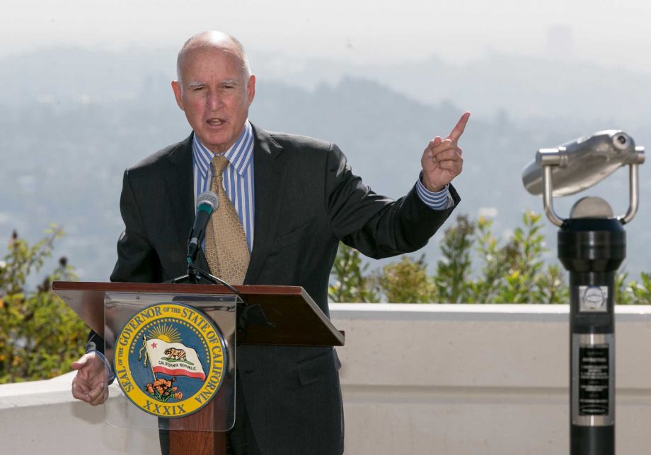 California Gov. Jerry Brown speaks before signing a bill to combat climate change by increasing the state's renewable electricity use to 50 percent and doubling energy efficiency in existing buildings by 2030 at a ceremony at the Griffith Observatory in L