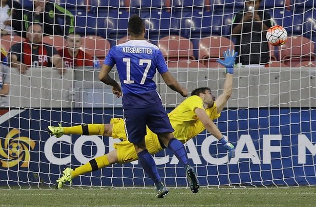 Canada goalkeeper Maxime Crepeau right dives in an attempt to stop the ball as United States forward Jerome Kiesewetter scores a penalty shot in the second half of a CONCACAF Men's Olympic qualifying soccer match Tuesday Oct. 13 2015 in Sandy Utah