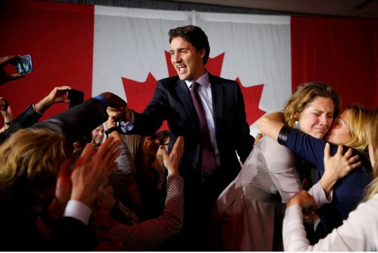 Liberal Party leader Justin Trudeau waves while accompanied by his wife Sophie Gregoire as he arrives to give his victory speech after Canada's federal election in Montreal Quebec