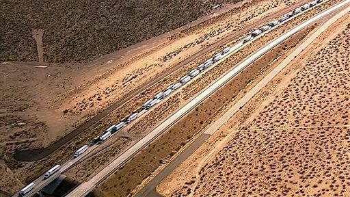 This image from video provided by KABC-TV shows some of hundreds of trucks and cars stranded on State Highway 58 near Mojave Calif. Friday Oct. 16 2015 after torrential rains Thursday caused mudslides that carried away vehicles and closed roads about