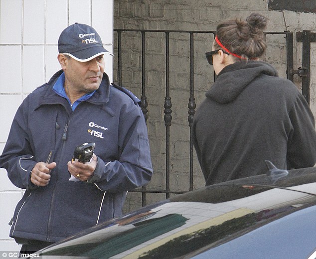 Caught in the act The 21-year-old singer was seen receiving a stern warning and a ticket from a traffic warden