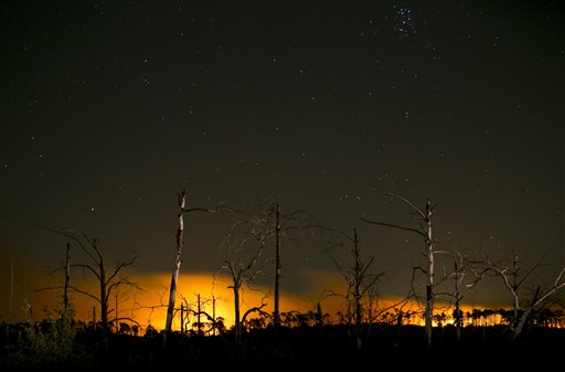 Flames from the Hidden Pines fire glow at night on Thursday Oct. 15 2015 Bastrop Texas. Residents of about 400 homes have been advised to evacuate since the fire began Tuesday officials said. The cause of the blaze is unknown. /Austin