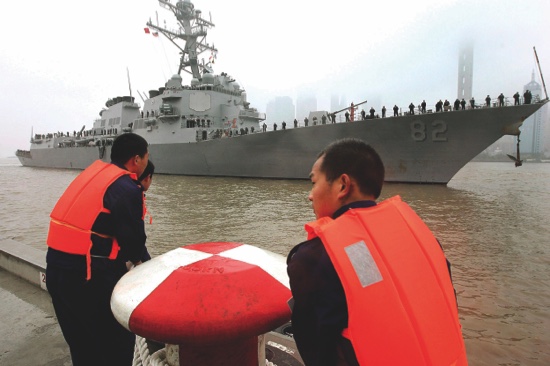 Chinese navy personnel get ready for the U.S. Navy guided missile destroyer USS Lassen to dock at the Shanghai International Passenger Quay