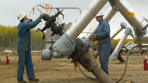 Employees work on a slant producing well at Mac Kay River oilsands about 97 kilometres north of Fort Mc Murray in northern Alberta