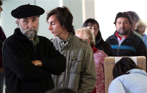 People lines up to vote at a polling station in Tigre outskirts of Buenos Aires Argentina Sunday Oct. 25 2015. Argentines are weighing continuity versus a financial overhaul in Sunday's elections as they pick the successor to President Cristina F