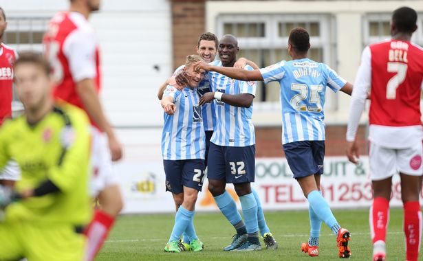 Coventry City's George Thomas celebrates the own goal that his shot created with his team mates as Fleetwood Town players look dejected