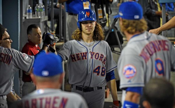 New York Mets pitcher Jacob de Grom is high-fived