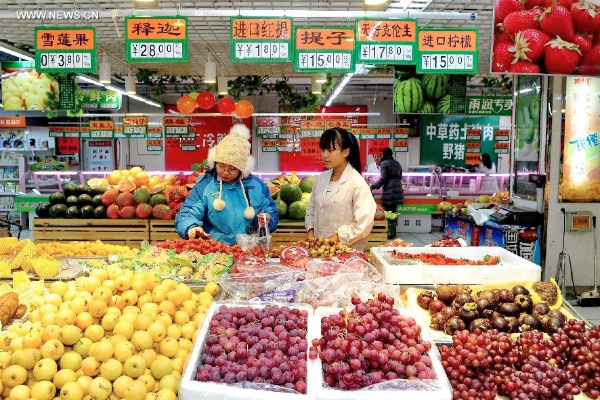 Customers purchase fruits in a supermarket in Cangzhou north China’s Hebei province