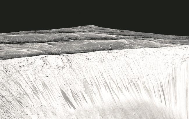 Dark narrow streaks called recurring slope lineae emanate out of the walls of Garni crater on Mars