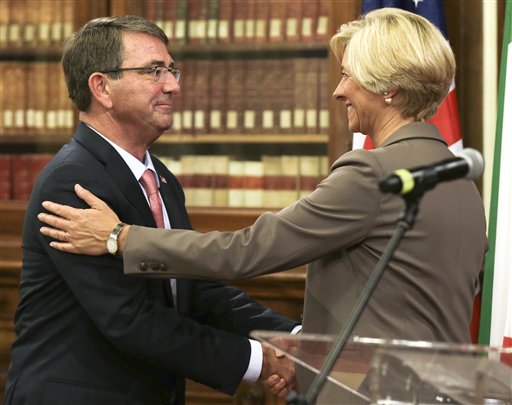 Italian Defense Minister Roberta Pinotti right and US Secretary of Defense Ashton Carter shake hands at the end of joint press conference on the occasion of their bilateral meeting in Rome Wednesday Oct. 7 2015