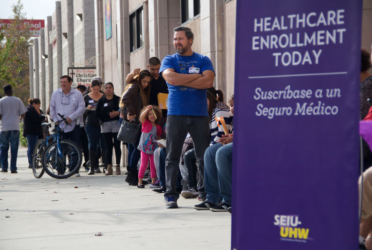 People in Los Angeles wait to enter an Affordable Care Act enrollment event sponsored in 2014 by the Service Employees International Union. A crush of new enrollees under the act is driving a 14 percent increase in Medicaid costs last year according to