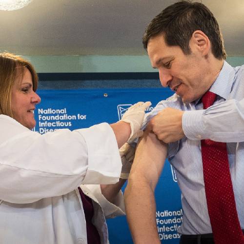 Frieden director of the Centers for Disease Control and Prevention receives a flu shot from Sharon Bonadies at the conclusion of a news conference at the National Press Club in Washington Thursday Sept. 18 2014.'Vaccination is