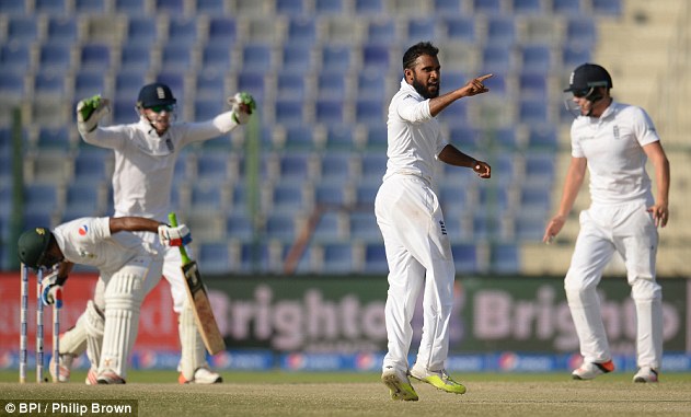 England bowler Adil Rashid celebrates after taking the wicket of Pakistan's Asad Shafiq in the first Test