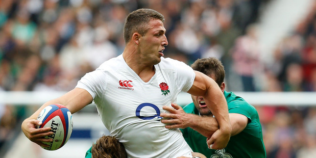 England's Sam Burgess tries to off load in the tackle during an international rugby union match between England and Ireland