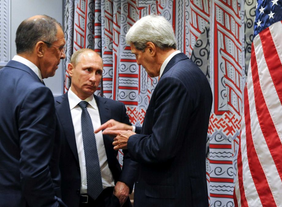 Russian President Vladimir Putin center and Foreign Minister Sergey Lavrov left listen to U.S. Secretary of State John Kerry right before a bilateral meeting at United Nations headquarters in New York Monday Sept. 28 2015. (Mikhail Klimentyev RI