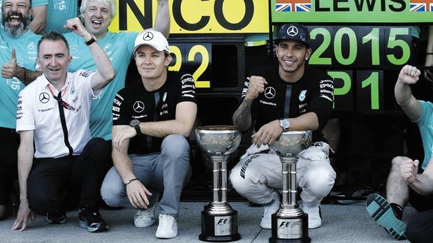 Lewis Hamilton and Mercedes team-mate Nico Rosberg pose with their trophies in Suzuka