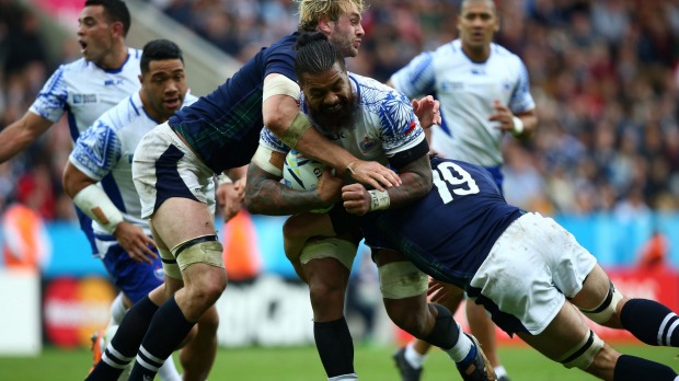 Faifili Levave of Samoa is tackled by Johnny Grey and Tim Swinton