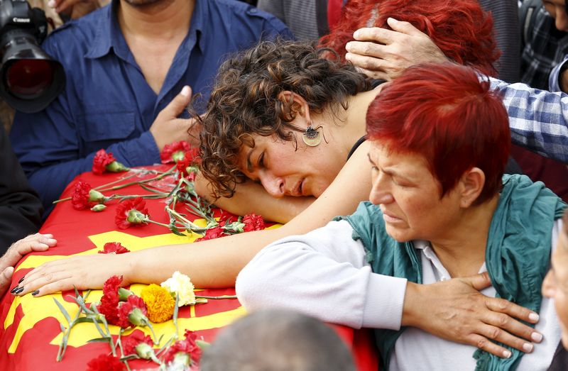 Family of a victim of the double suicide bombing in Ankara mourn over his coffin during a funeral ceremony in Turkey. – Reuters pic