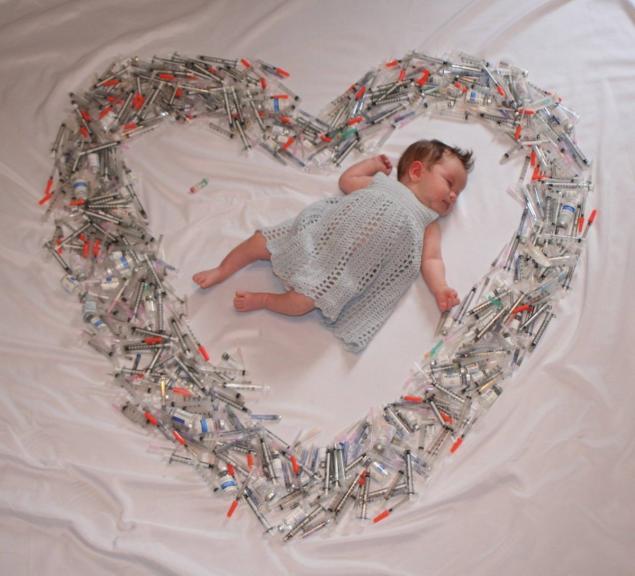 Photo of baby surrounded by heart of syringes causes stir