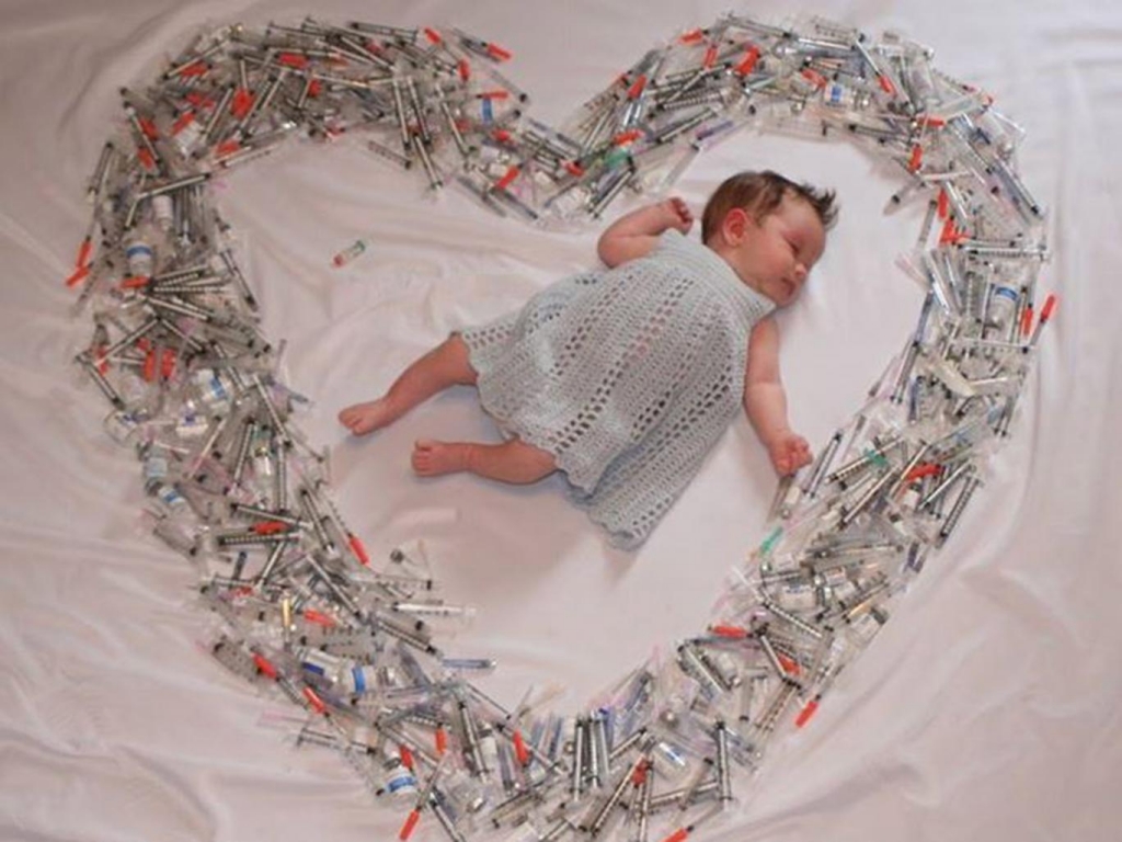 Photo of baby surrounded by heart of syringes causes stir