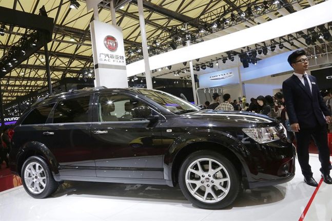 Fiat Freemont is displayed at the automaker's booth next to Chrysler's booth at the Shanghai International Automobile Industry Exhibition in Shanghai China. Fiat Chrysler is recalling 894,000 Je