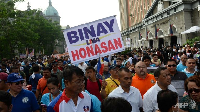 A supporter of opposition presidential candidate Jejomar Binay displays a placard during the filing of Certificate of Candidacy at the commission on elections in Manila on Monday. The Philippines election season kicked off with politicians registering