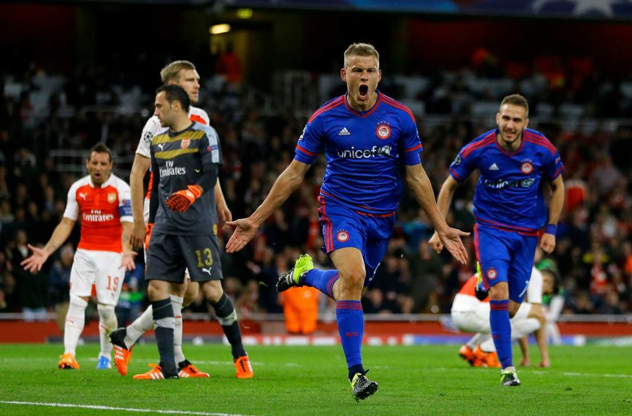 Olympiakos Alfred Finnbogason centre celebrates after scoring his side's third goal during the Champions League Group F soccer match between Arsenal and Olympiakos at Emirates stadium in London Tuesday Sept. 29 2015