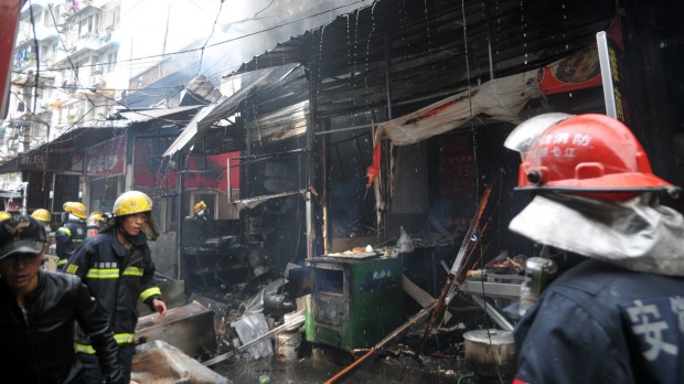 Firemen work to put out a fire following an explosion in a restaurant in Wuhu city on Saturday