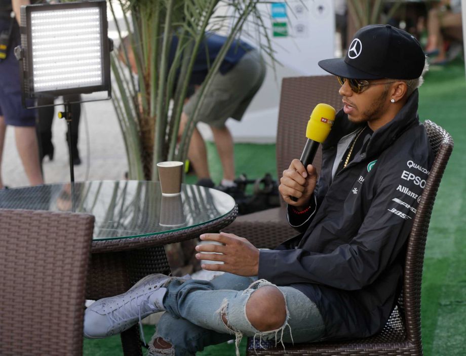 Mercedes driver Lewis Hamilton of Britain talks with a reporter during an interview at the'Sochi Autodrom Formula One track, in Sochi Russia Thursday Oct. 8 2015. The Formula one race will be held on Sunday