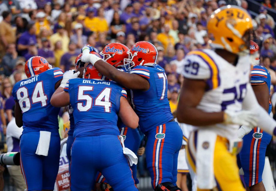 Florida tight end Jake Mc Gee is hugged by teammates after catching a touchdown pass in the first half of an NCAA college football game against LSU in Baton Rouge La. Saturday Oct. 17 2015. If the Gators win Sa