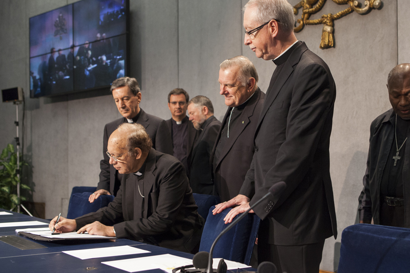 Cardinal Oswald Gracias center front president of the Federation of Asian Bishops Conferences signs the climate change appeal on Oct. 26 2015 at the Vatican