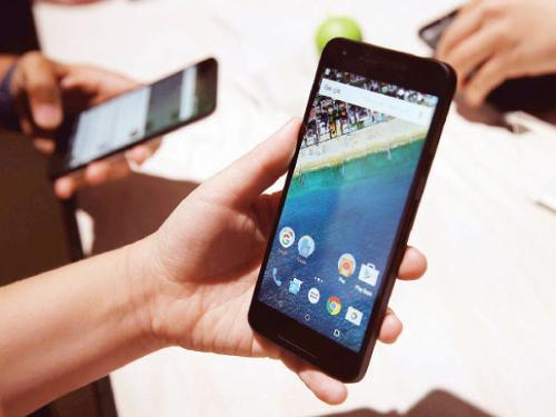 An attendee inspects the new Nexus 5X phone during a Google media event in San Francisco California. Google unveiled its 2015 smartphone lineup the Nexus 5x and Nexus 6P the new Chromecast and new Android 6.0 Marshmallow software features. — AFP