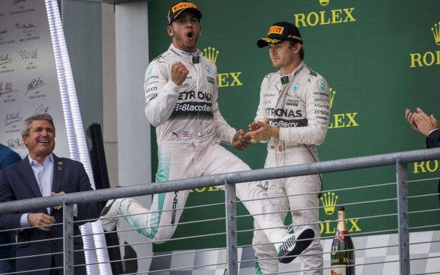 Lewis Hamilton celebrates after winning the US F1 Grand Prix as teammate Nico Rosberg of Germany applauds at the Circuit of The Americas in Austin Texas on Oct 25 2015