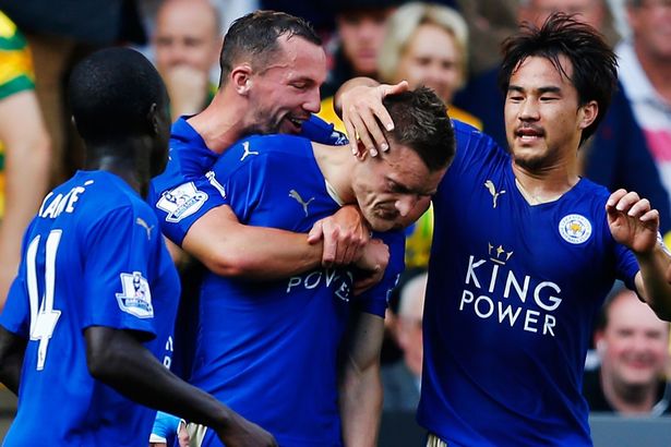 Jamie Vardy celebrates scoring with his team mates after scoring the first goal from the penalty spot