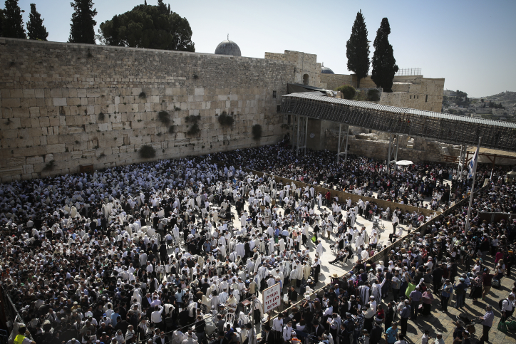 Jewish worshipers cover themselves with prayer shawls during the Passover priestly blessing ceremony as they pray at the Western Wall in Jerusalem's Old City