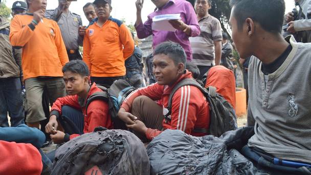 Hikers who escaped the forest fire on Lawu Mountain rest at Cemoro Sewu East Java