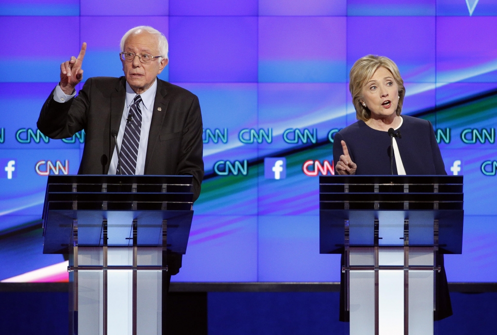 Hillary Rodham Clinton right and Sen. Bernie Sanders of Vermont speak during the CNN Democratic presidential debate on Tuesday