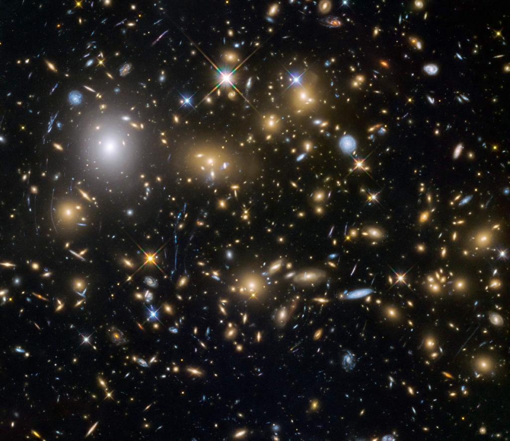 New images from the NASA ESA Hubble Space Telescope show the faintest and earliest known galaxies in the Universe. This image shows the galaxy cluster MACSJ0717.5+3745. It is one of the most massive galaxy clusters known and it is also the lar