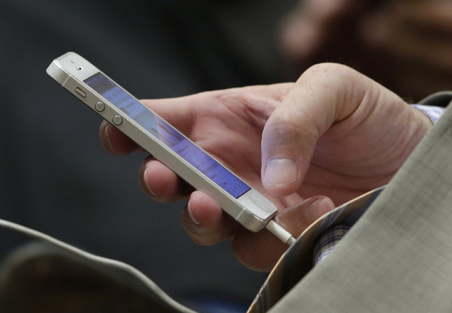 State Sen. Anthony Canella R-Ceres uses his smartphone at the Capitol in Sacramento Calif. California Gov. Jerry