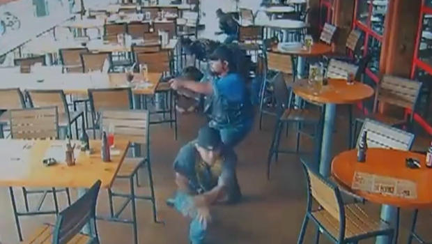 In this surveillance video a biker is shown pointing his gun in a massive shootout between biker gangs.         
                                     CBS affiliat