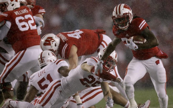 Running back Dare Ogunbowale picks up some of UW’s 581 yards rushing against Nebraska last year