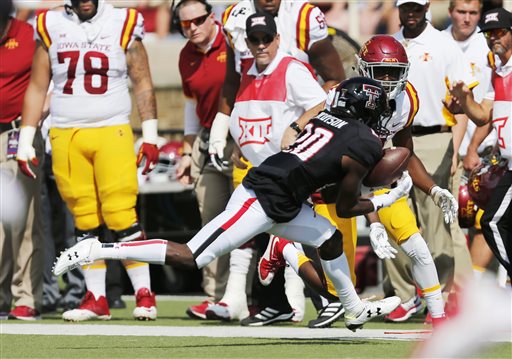 Texas Tech's Tevin Madison intercepts a pass intended for Iowa State's D'Vario Montgomery during an NCAA college football game Saturday Oct. 10 2015 in Lubbock Texas