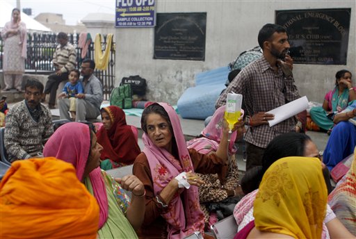 Patients who were shifted outdoors at the government medical college hospital sit after a strong tremor was felt in Jammu India Monday Oct. 26 2015. A strong earthquake in northern Afghanistan was felt across much of South Asia on Monday shaking buil