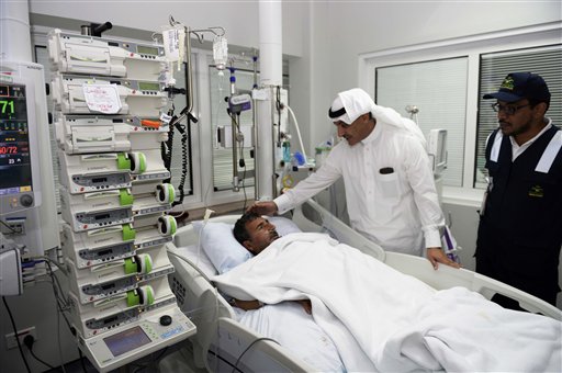 Saudi state news agency Saudi Press Agency, an official from the Saudi Health Ministry talks to a victim who was injured in Thursday's stampede during the hajj pilgrimage in Mina as he visi